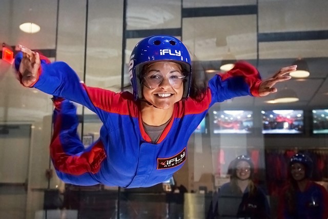 Smiling woman flying at iFLY