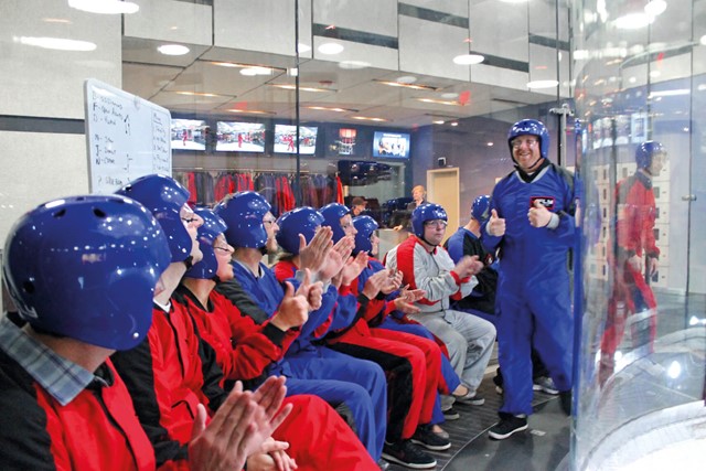 A group applauding one of the flyers