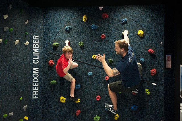 A boy and instructor at Freedom Climber